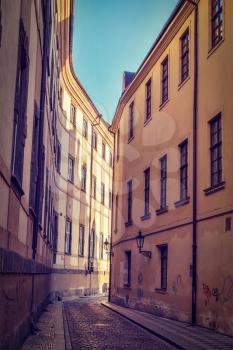 Vintage retro hipster style travel image of Prague street with old houses, Prague, Czech Republic