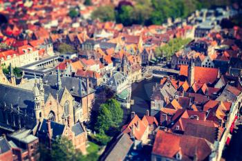 Aerial view of Bruges (Brugge) from Belfry, Belgium. Tilf shift effect. Cross processed vintage retro style.