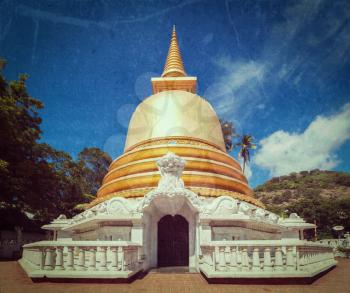 Vintage retro hipster style travel image of buddhist dagoba (stupa) close up  with grunge texture overlaidin Golden Temple, Dambulla, Sri Lanka