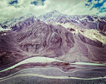 Vintage retro effect filtered hipster style travel image of Spiti valley, river, road in Himalayas. Himachal Pradesh, India