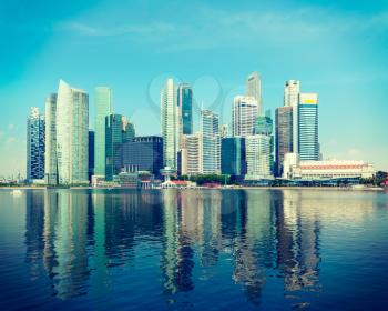 Vintage retro hipster style travel image of Singapore skyline of business district and Marina Bay in day