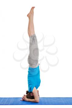 Yoga - young beautiful woman yoga instructor doing headstand (sirsasana) asana exercise isolated on white background