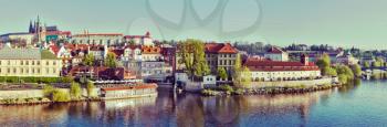 Vintage retro hipster style travel image of panorama of historic center of Prague:  Gradchany (Prague Castle) and St. Vitus Cathedral in the morning