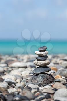 Zen meditation background -  balanced stones stack close up on sea beach