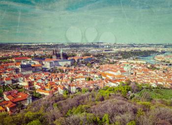 Vintage retro hipster style image of aerial view of Hradchany the Saint Vitus Cathedral and Prague Castle from Petrin Observation Tower with grunge texture overlaid. Prague, Czech Republic