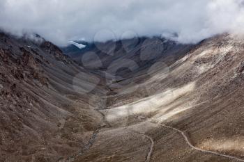 Himalayan valley landscape with road near Kunzum La pass - allegedly the highest motorable pass in the world (5602 m), Ladakh, India