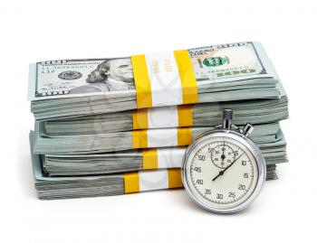 Time is money concept - stopwatch and stack of new 100 US dollars 2013 edition banknotes bills bundles isolated on white
