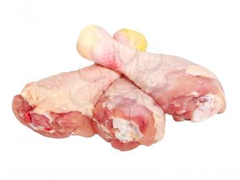 Three uncooked chicken legs isolated on a white background.