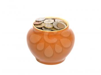 Ceramic pot with metal money on the white background.
