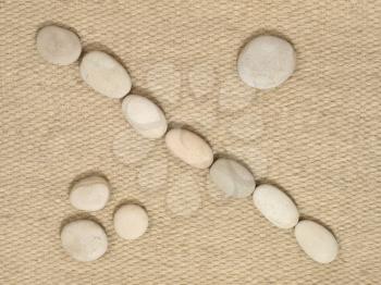 A row of small stones on a wool fabric as background.