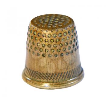 Old bronze sewing thimble isolated on white background taken closeup.