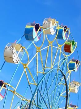 Colorful carousel against of the summer blue sky.