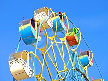 Colorful carousel against of the blue sky.