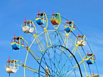 Colorful carousel against of the summer blue sky.