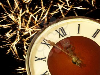 Eve of new year.Clock face and golden firework taken closeup.
