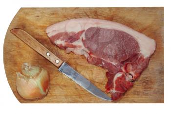 Raw pork meat, knife and onion on wooden cutting board.Isolated.Top view.
