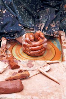 Potter hands in the process of the pottery manufacturing.