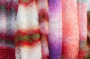 Color orenburg shawls taken closeup hanging for sale.