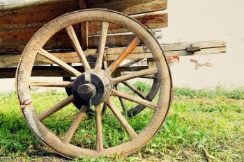 Wheel of old wooden cart taken closeup.Toned image.