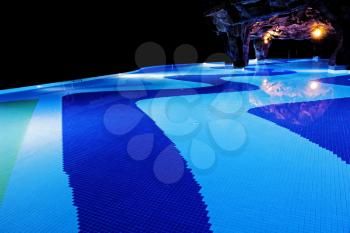 Illuminated swimming pool in darkness.