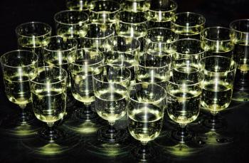 White sparkling wine in glasses on holiday reception table at nightclub.Toned image.