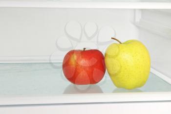 Yellow and red apple in domestic refrigerator taken closeup.Healthy lifestyle.