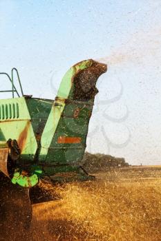 Combine harvester machine tractor in agriculture field.Back view taken closeup.