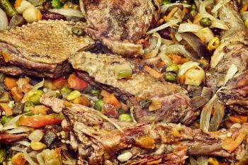 Appetizing roasted meat with vegetables taken closeup.Toned image.