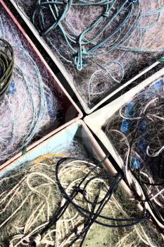 Old fishing nets in container on dock