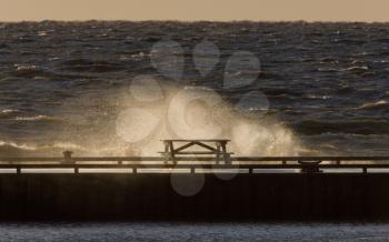 Waves crashing over pier Lake Winnipeg Manitoba