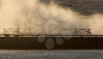 Waves crashing over pier Lake Winnipeg Manitoba
