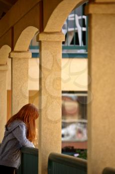 Redheaded girl on balcony in Moose Jaw