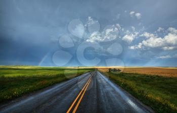 Rainbow and wet country highway in Saskatchewan