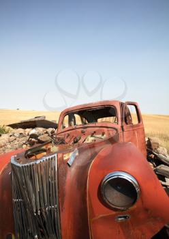 Wide angle of abandoned vehicle in scenic Saskatchewan