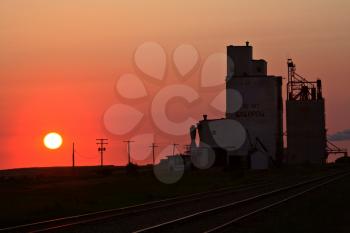 Sun setting behind Eyebrow grain terminal in Saskatchewan