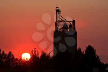 Sun setting behind Eyebrow grain terminal in Saskatchewan
