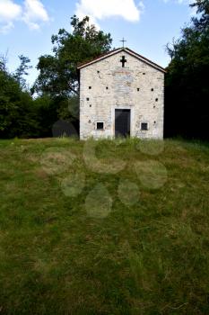  italy  lombardy     in  the arsago seprio   old   church   closed brick tower      wall grass