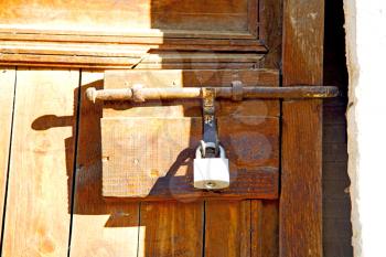 metal grey       morocco in    africa the old wood  facade home and rusty safe padlock 