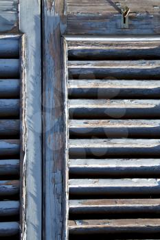 grey window   castellanza   palaces italy   abstract  sunny day    wood venetian blind in the concrete  brick  
