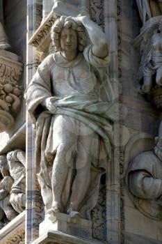 italy statue of a women in the front of the duomo  church in milan and incision
