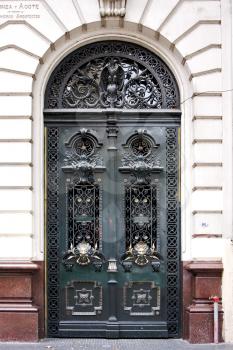 brown wood old green door and  head of lion in a house the centre buenos aires argentina 