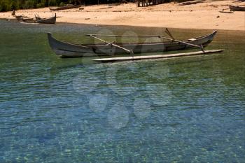 boat sand lagoon  water reflex and coastline in madagascar nosy be