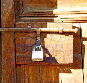 metal grey       morocco in    africa the old wood  facade home and rusty safe padlock 