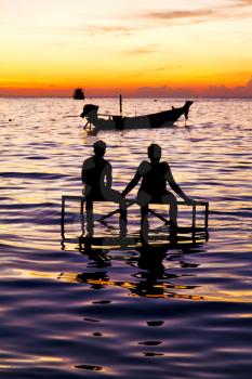 sunrise people boat  and water in thailand kho tao bay coastline south china sea