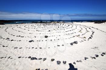 spain  isle white  beach  spiral of black rocks in the   lanzarote 
