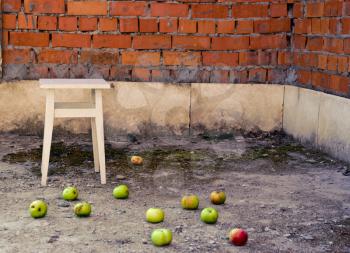 apples scattered on the floor against the backdrop of the old interior