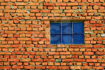 Window from blue glass blocks on brick wall