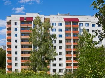 Typical modern residential building in the park area in summer time