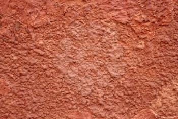 Detail of old red wall with shelled stucco