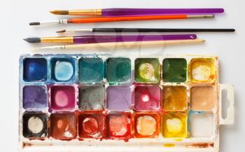 Closeup of water-color paint-box and paint brushes